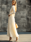 Cream satin pleated maxi dress by FJØRNA, featuring a flowing design, pleats, and elegant casual style.