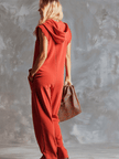 Raspberry red women's cotton hooded zip-front jumpsuit by FJØRNA, featuring a comfortable fit and stylish design.