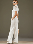White cotton blend wide-leg jumpsuit for women by FJØRNA, featuring short sleeves and a relaxed fit.