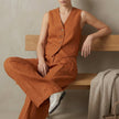 Orange linen two-piece pleated co-ord set for women by FJØRNA, featuring a stylish, elegant design perfect for casual or dressy wear.