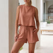 Orange-red women's summer two-piece co-ord set with pleated design, featuring a matching top and skirt by FJØRNA.