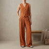 Orange FJØRNA women's two-piece linen pleated co-ord set with a stylish top and matching skirt, perfect for elegant casual wear.