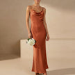 Orange FJØRNA women's maxi dress with cowl neck and cami straps, elegant flowy design perfect for casual or formal occasions.