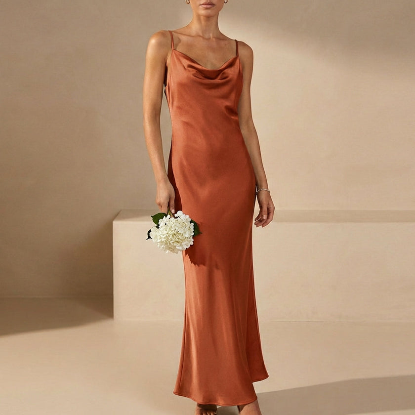 Orange FJØRNA women's maxi dress with cowl neck and cami straps, elegant flowy design perfect for casual or formal occasions.