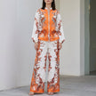 Orange floral two-piece wide-leg co-ord set for women by FJØRNA, featuring a stylish and elegant matching top and pants.
