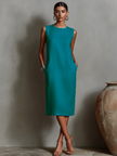 Orange linen sleeveless mini dress for women by FJØRNA, perfect for casual or evening wear, shown on a model.