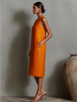 Orange linen sleeveless mini dress for women by FJØRNA, perfect for casual or evening wear, shown on a model.