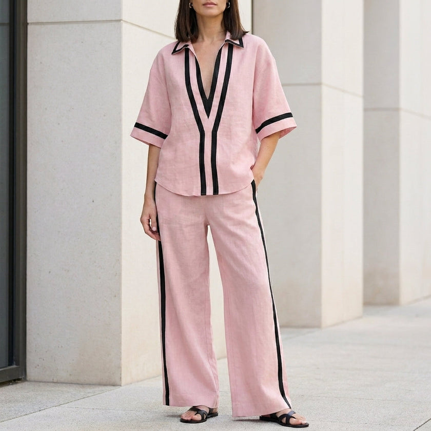 Pink two-piece women's co-ord set by FJØRNA featuring a wide-leg pant and V-neck top, stylish and elegant for casual or dressy wear.