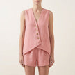 Pink FJØRNA women's two-piece co-ord set with button-front V-neck top and matching pants, stylish and elegant for any occasion.