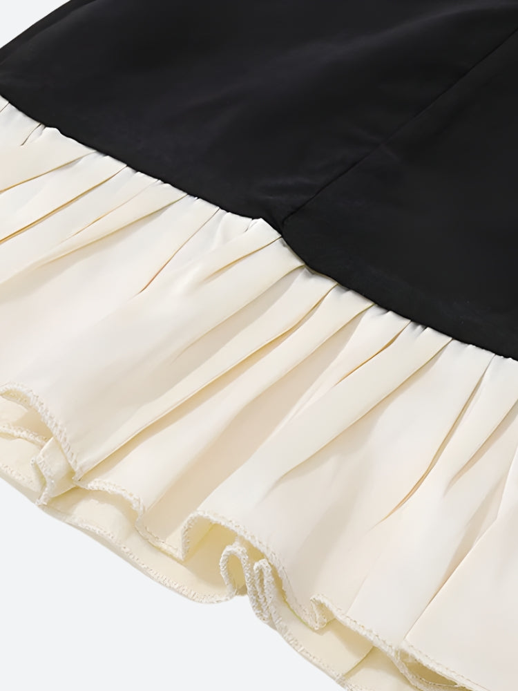 FJØRNA women's mini dress with pleated hem, suitable for party and day wear, showcased on a model.
