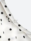 FJØRNA polka dot women's mini dress featuring a stylish party and day wear design, with a fitted silhouette and playful pattern.