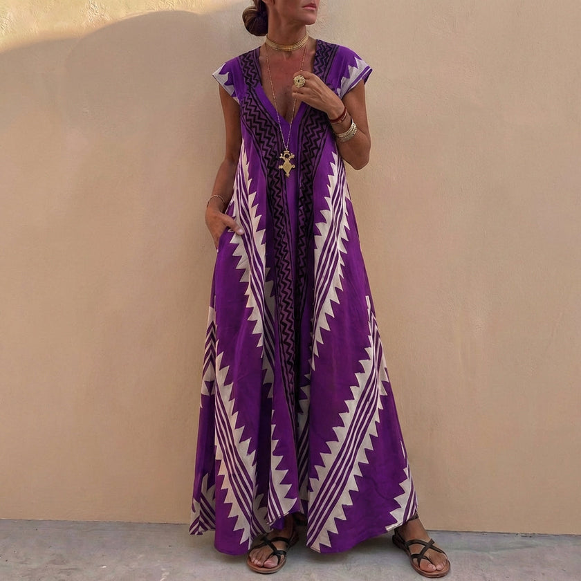 Purple FJØRNA women's elegant maxi dress with geometric V-neck, flowing fabric, and sleeveless design for a stylish look.