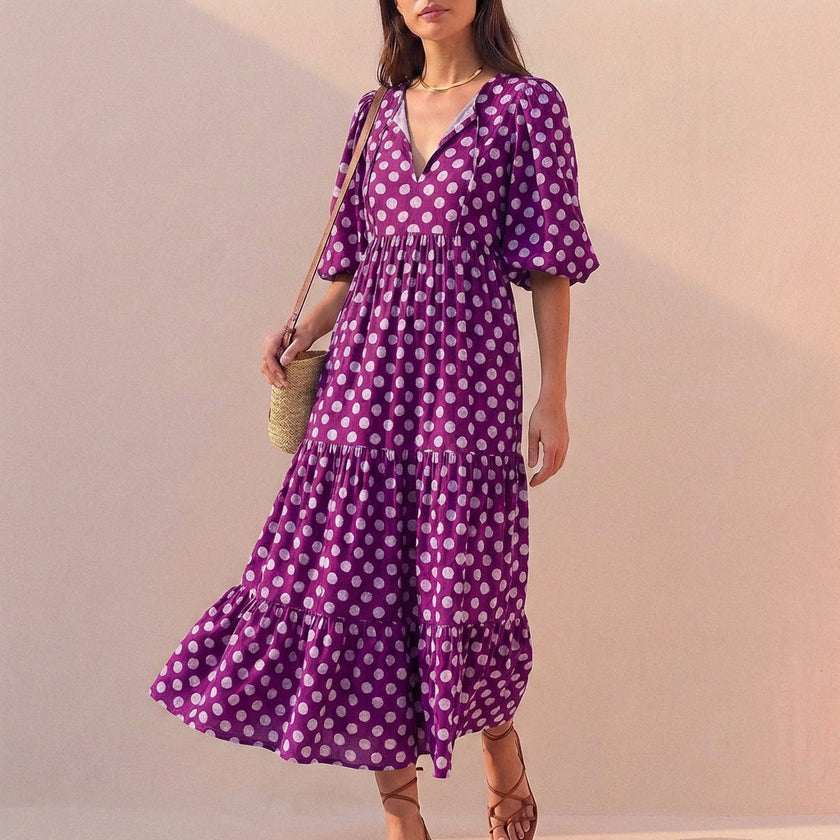 Purple FJØRNA women's elegant maxi dress with V-neck and puff sleeves, flowing and stylish for sophisticated occasions.