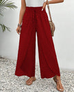 FJØRNA women's lightweight summer trousers in red with wide leg design, breathable fabric perfect for warm weather.