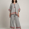 Red and white striped women's summer two-piece co-ord set with wide-leg pants by FJØRNA, ideal for casual warm-weather outfits.