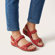Red FJØRNA orthopedic comfort fit sandals with adjustable strap and open toe, designed for supportive casual wear.