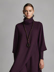 Red cotton turtleneck maxi dress by FJØRNA, featuring a fitted bodice and flowing skirt, ideal for elegant evening wear.