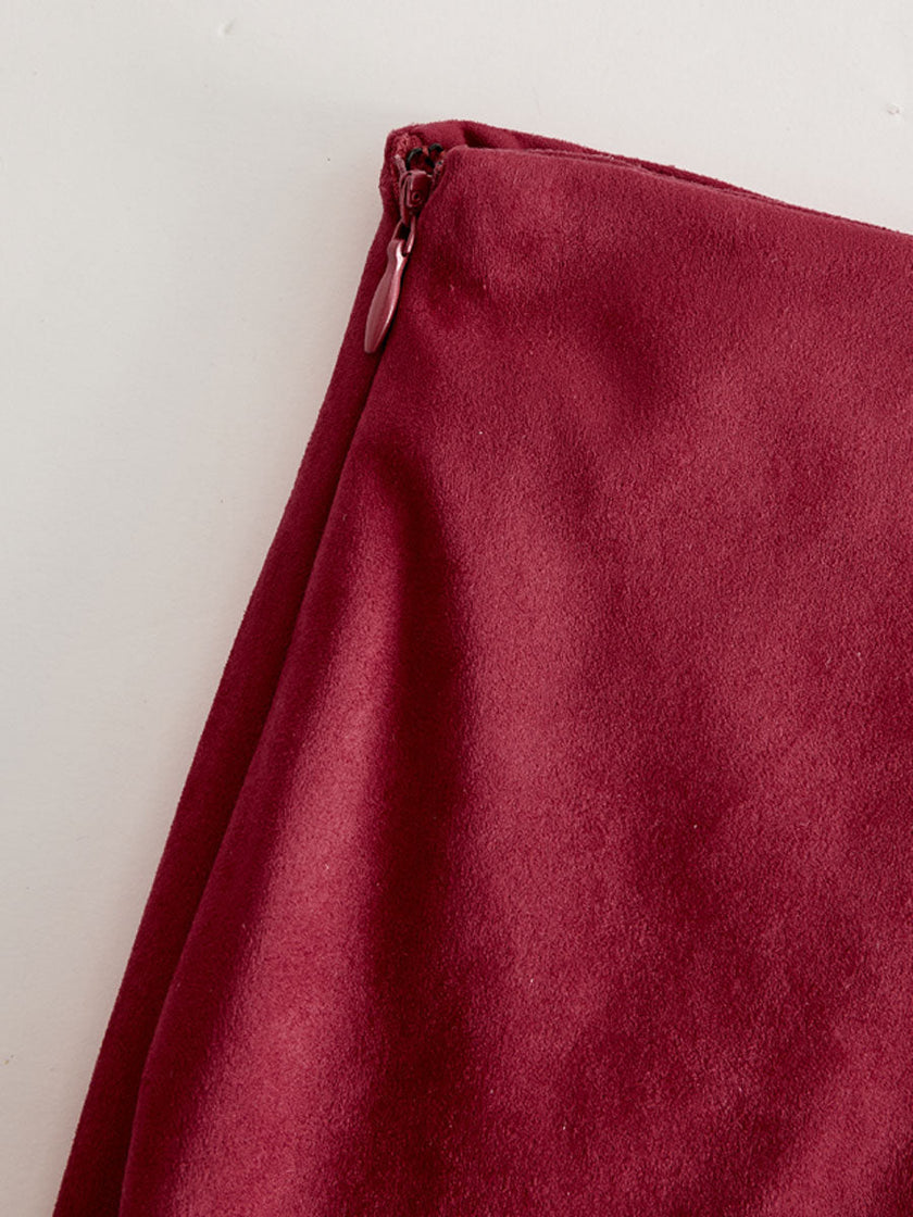 Red faux suede midi dress with slit, casual style by FJØRNA, featuring a fitted bodice and flowing skirt.