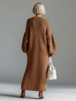 Red knit maxi dress by FJØRNA, flowing evening dress with long sleeves and a fitted waist, perfect for elegant occasions.