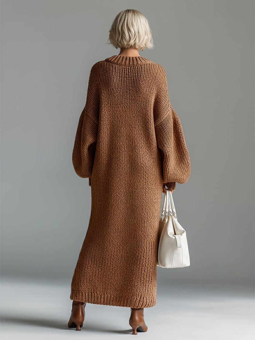 Red knit maxi dress by FJØRNA, flowing evening dress with long sleeves and a fitted waist, perfect for elegant occasions.