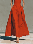 Red linen halter neck maxi dress by FJØRNA, casual dress with flowing silhouette and sleeveless design, shown on a model.