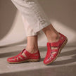 Red FJØRNA orthopedic closed-toe sandals with cutout details and a comfortable fit, showcasing the stylish and supportive design.