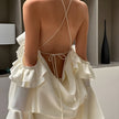 FJØRNA rose ruffled mini dress with layered ruffle details, perfect for party or daytime wear, shown on a model.