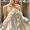 Rose ruffled mini dress by FJØRNA featuring a feminine design, perfect for party or daytime wear, shown on a model.