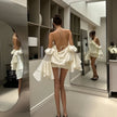 FJØRNA rose ruffled women's mini dress with floral details, perfect for party or daytime wear, shown on a model.