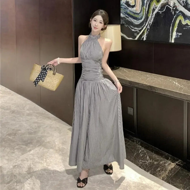 FJØRNA ruched halter women's midi dress with a stylish design, perfect for day-to-night wear, shown on a model.