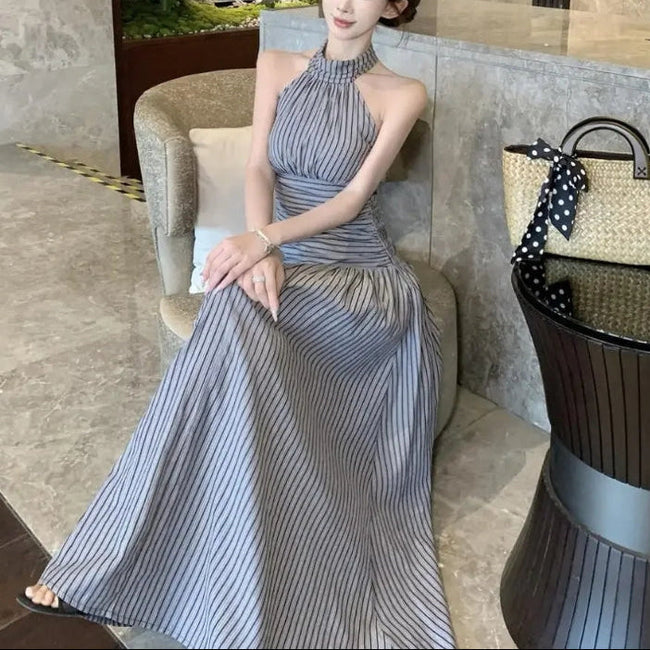FJØRNA ruched halter women's midi dress featuring a stylish design, perfect for day-to-night wear, shown in the image.