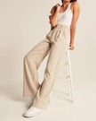 White wide-leg high-waist trousers for women by FJØRNA, featuring a relaxed fit and tailored high-rise design.