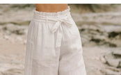FJØRNA linen wide-leg trousers for women, loose pull-on pants in a relaxed fit, shown in a neutral color.