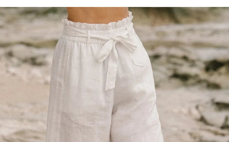 FJØRNA linen wide-leg trousers for women, loose pull-on pants in a relaxed fit, shown in a neutral color.