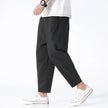 Men's cropped linen trousers in indigo by FJØRNA, featuring a relaxed fit and lightweight fabric for casual style.