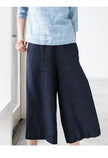 FJØRNA women's linen wide-leg trousers with drawstring waist, pull-on style, soft fabric, and relaxed fit.