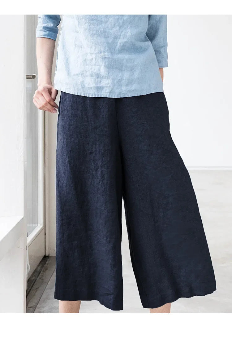 FJØRNA women's linen wide-leg trousers with drawstring waist, pull-on style, soft fabric, and relaxed fit.