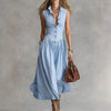 FJØRNA Martina elegant white flowy midi dress with a loose fit and soft fabric, perfect for sophisticated casual or evening wear.