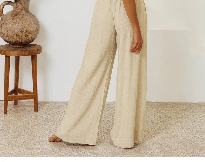 FJØRNA linen wide-leg trousers for women, loose pull-on pants with a relaxed fit and wide-leg design, shown in natural fabric.