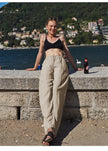 FJØRNA women's knit wide-leg trousers with drawstring waist, soft fabric, and relaxed fit, styled on a model.
