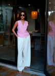 FJØRNA linen blend wide-leg high-waist women's trousers laid flat, showing neutral color and tailored fit.