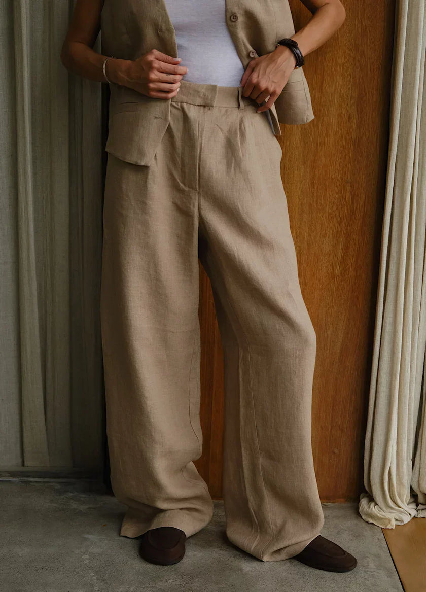 FJØRNA women's linen blend wide-leg high-waist trousers, stylish and comfortable pants for women, shown in natural fabric texture.