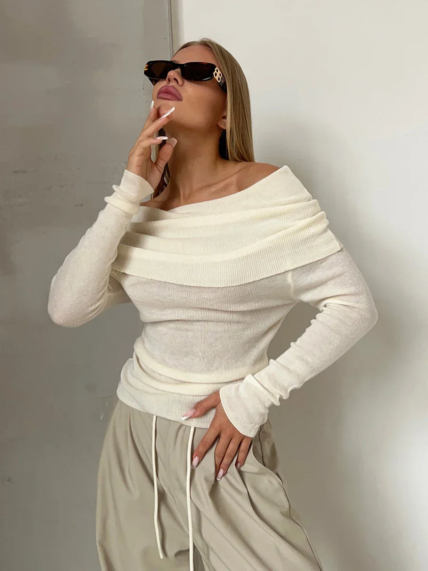 FJØRNA ribbed knit off-shoulder women's top with mock neck, featuring a fitted design and soft fabric in a neutral color.