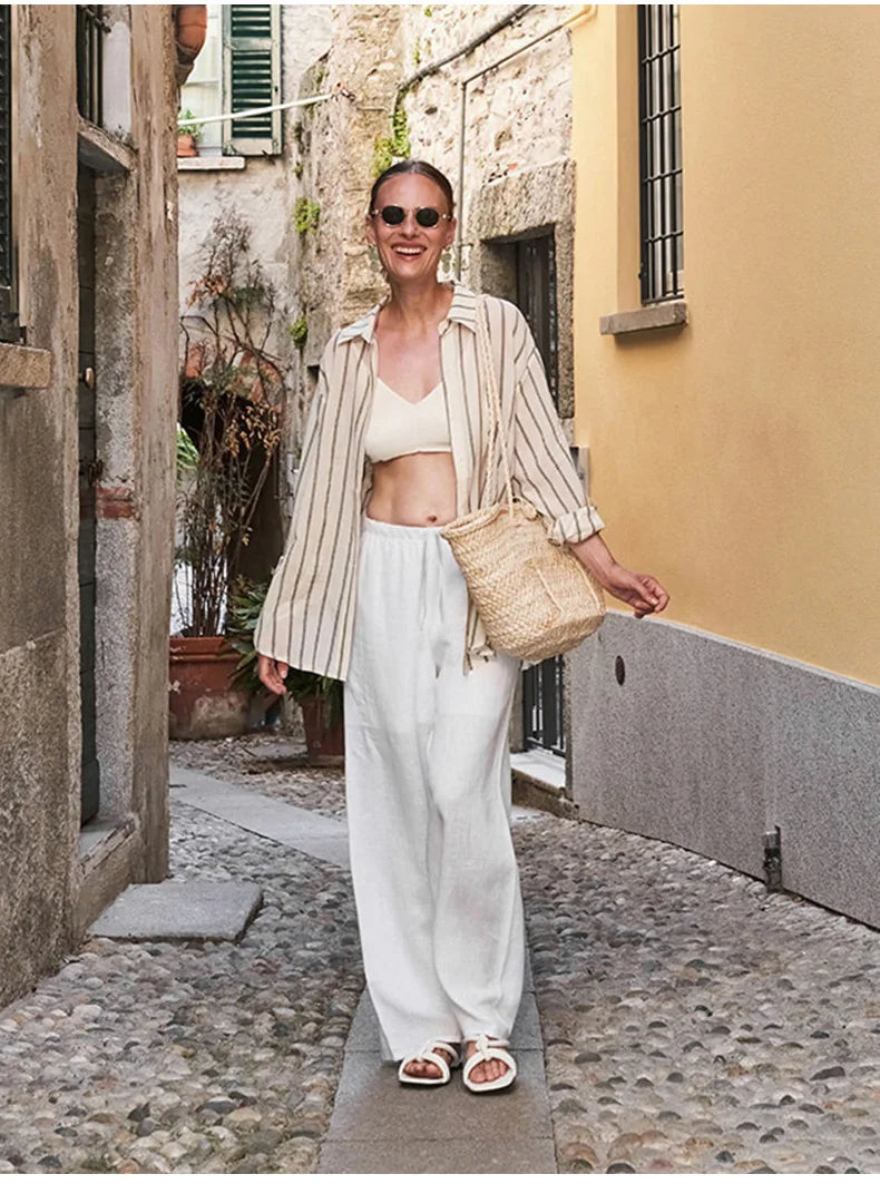 FJØRNA women's knit wide-leg trousers with drawstring waist, featuring a relaxed fit and soft fabric, shown in neutral color.