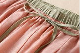 FJØRNA women's linen tapered trousers displayed on a model, showcasing lightweight, breathable fabric and relaxed fit.