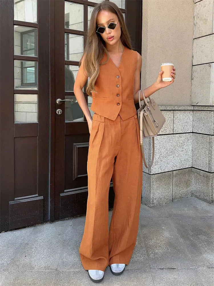 FJØRNA linen wide-leg trousers for women, part of a co-ord set, shown in a relaxed fit with a lightweight, breathable fabric.