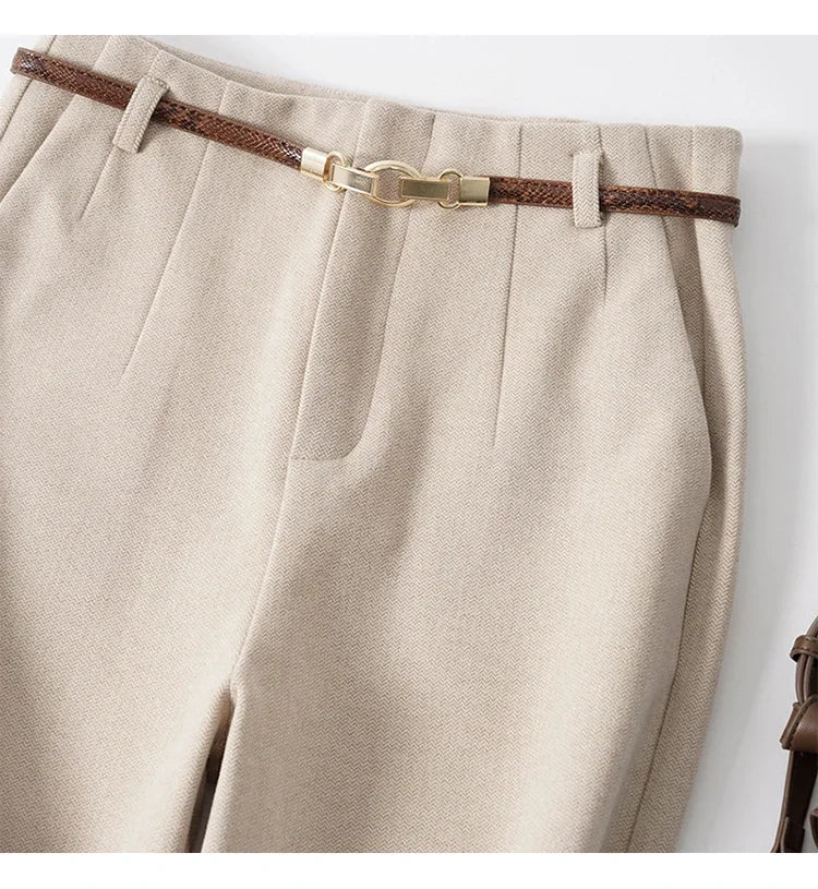 Women's wool wide-leg trousers by FJØRNA with high waist and tailored fit, styled for a sophisticated look.