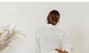 FJØRNA linen wide-leg women's trousers with a loose, pull-on style, featuring a relaxed fit and lightweight fabric.