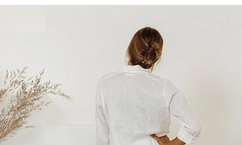 FJØRNA linen wide-leg women's trousers with a loose, pull-on style, featuring a relaxed fit and lightweight fabric.