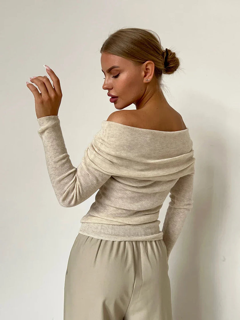 FJØRNA ribbed knit off-shoulder women's top with mock neck, showcasing the fitted, textured fabric and stylish off-shoulder design.